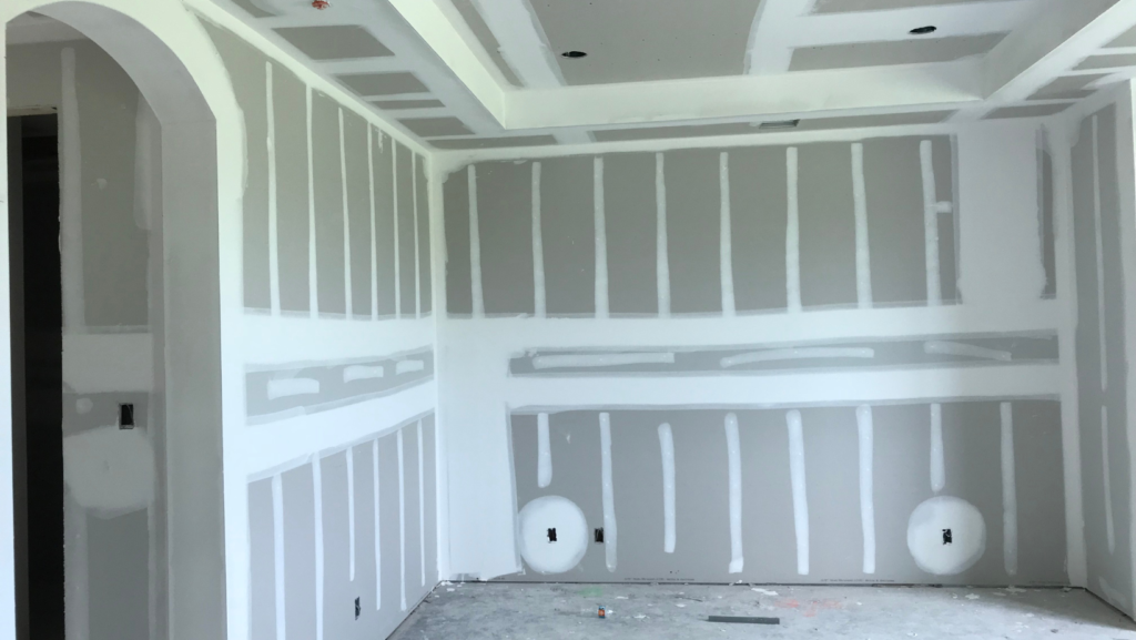 Professional team completing a drywall project with precise installation and smooth finishing.